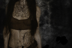 Title: CityGirl. A 3/4 full bodyportait of a girl with a big chest tattoo and a tattoo that covers the left side of her abdomen. She has long black hair. Rendered in Daz Studio and postwork done in Adobe Photoshop using several textures and overlays to create a grunge look. The image is mostly black and while except the girl whom has a slight sepia tone to her.